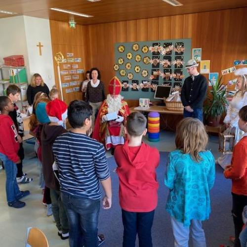 Nikolaus-Besuch in der 4b - Kinder stehen beim Gedichtaufsagen im Kreis