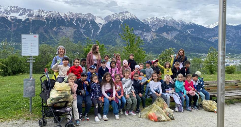 Die Kinder zeigen ihre vollen Müllsäcke